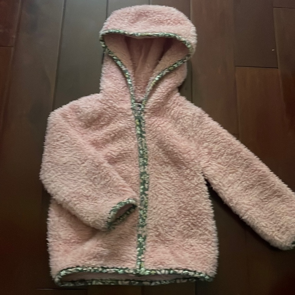This is a cute pink zip up that’s the size 18 months. My kid loved it.